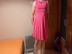 Sissy in pink dress strokes her cock with cumshot on face